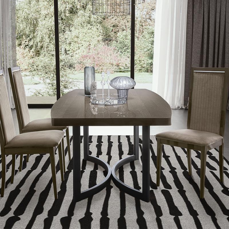 Armonia dining chairs by Modum - ribbed upholstered chair backs and a walnut table edge in detail