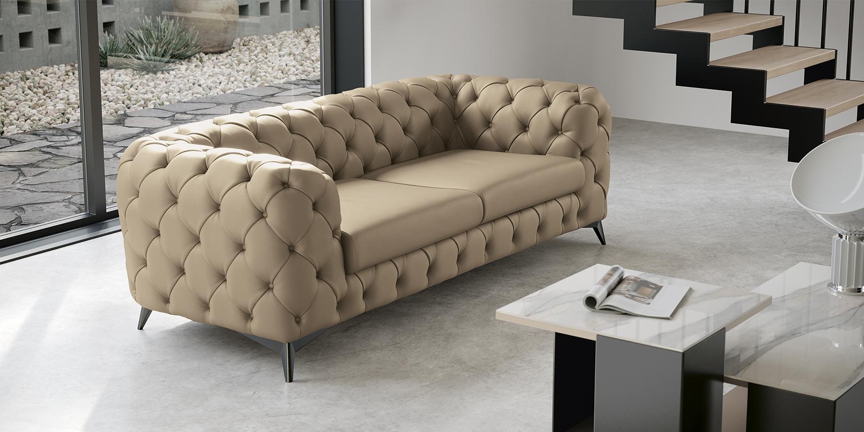 Zenith Day sofa in beige tufted upholstery beside a marble coffee table in a neutral contemporary room
