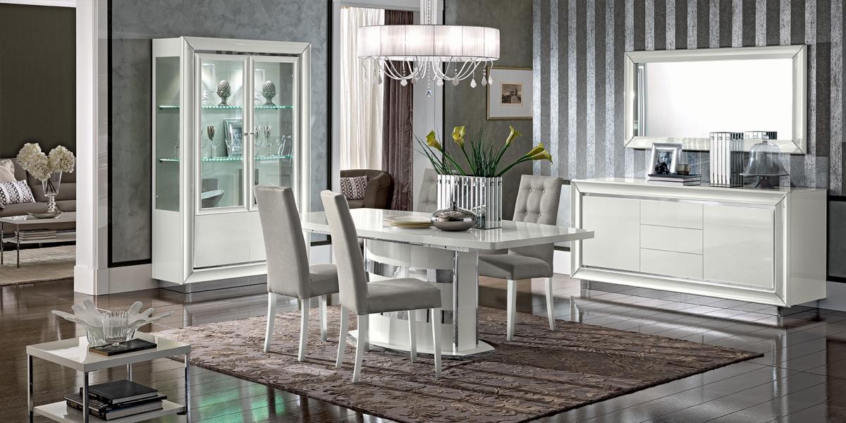 Dama Bianca dining table by Modum - white gloss table with tufted chairs and a glass display cabinet