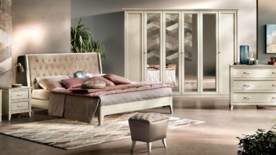 Ivory lacquer Giotto bedroom suite with an upholstered headboard, nightstands and a wardrobe.