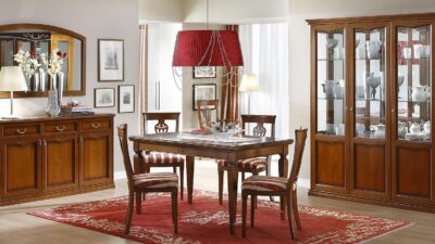 Walnut dining set with a round pedestal table and upholstered chairs.
