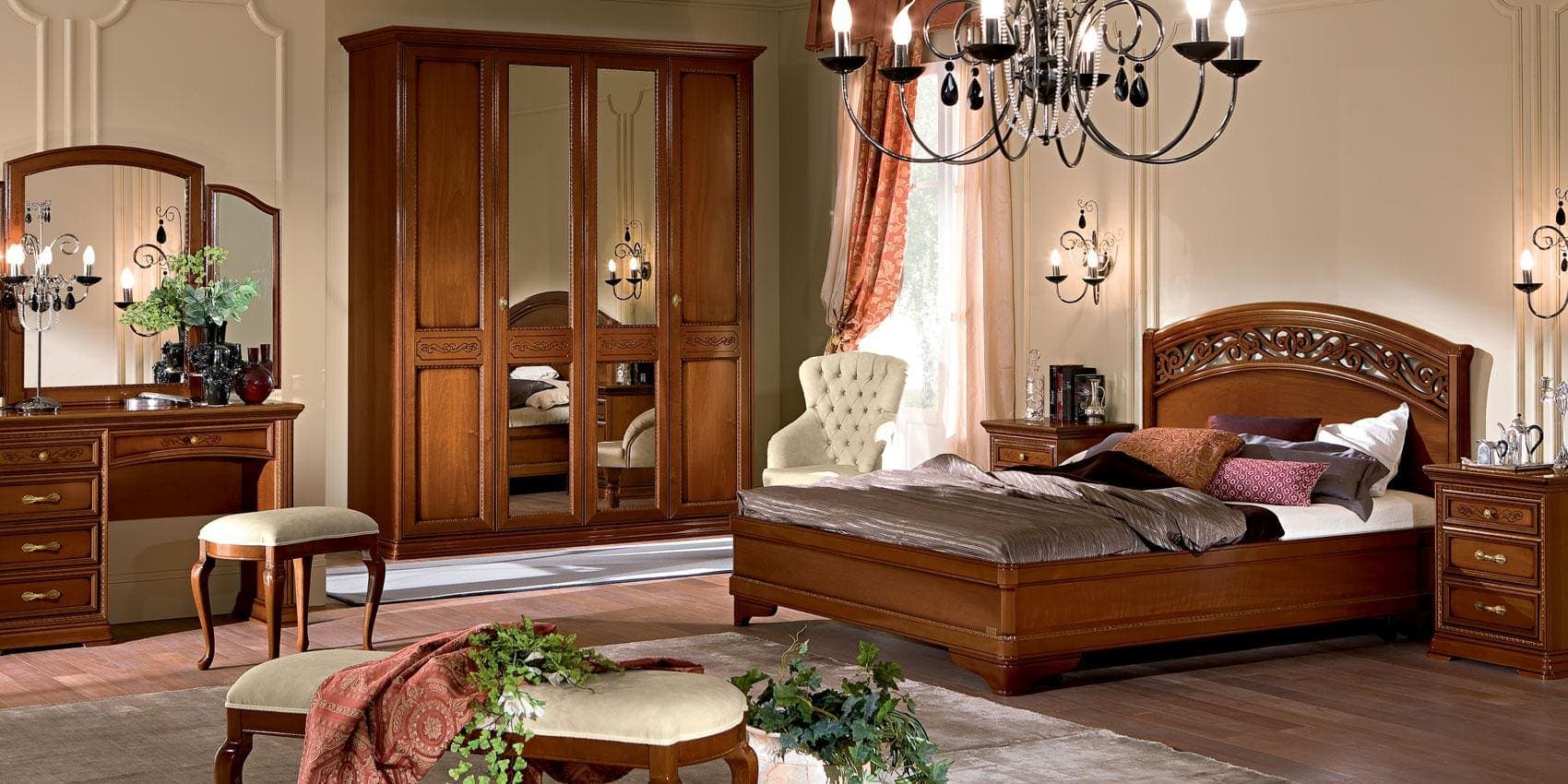 Walnut Torriani wardrobe with mirrored doors beside the bed in a styled bedroom.