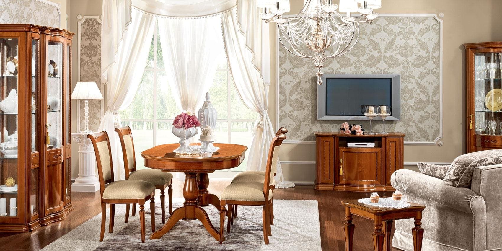 Oval walnut Torriani dining table with chairs in a room view.