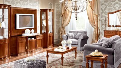 Walnut Torriani living room wall unit with TV console flanked by glass-fronted display cabinets, shown in a classic setting.