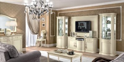 Ivory (Avorio) lacquer Torriani living room wall unit with TV console and flanking display cabinets in a light, classic interior.