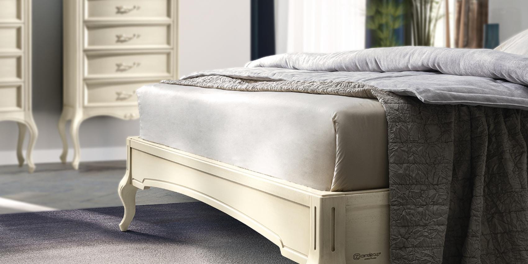 Verdi classic Italian cream bedroom bed with button-tufted headboard and dark grey throw by Camelgroup.